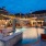 a pool with a fountain and buildings around it