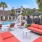 a pool and lounge chairs next to a house