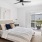 a bedroom with a bed and a fan